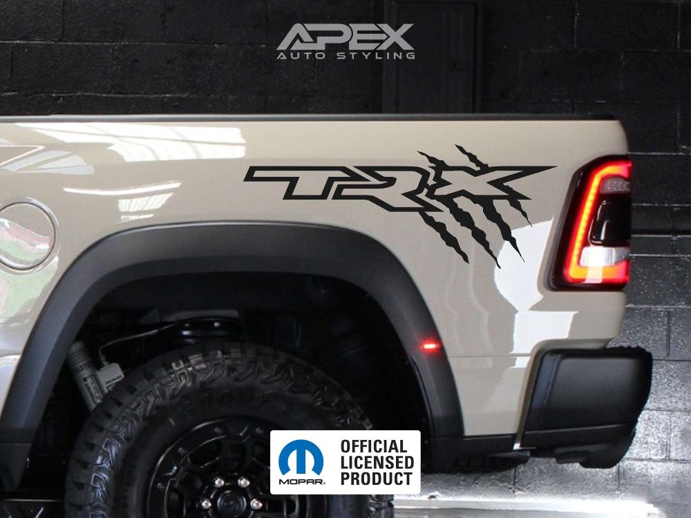 RAM TRX bedside decal with claw marks on a white truck, showcasing the custom vinyl design for the OEM-sized logo. Apex Auto Styling branding visible in the background.