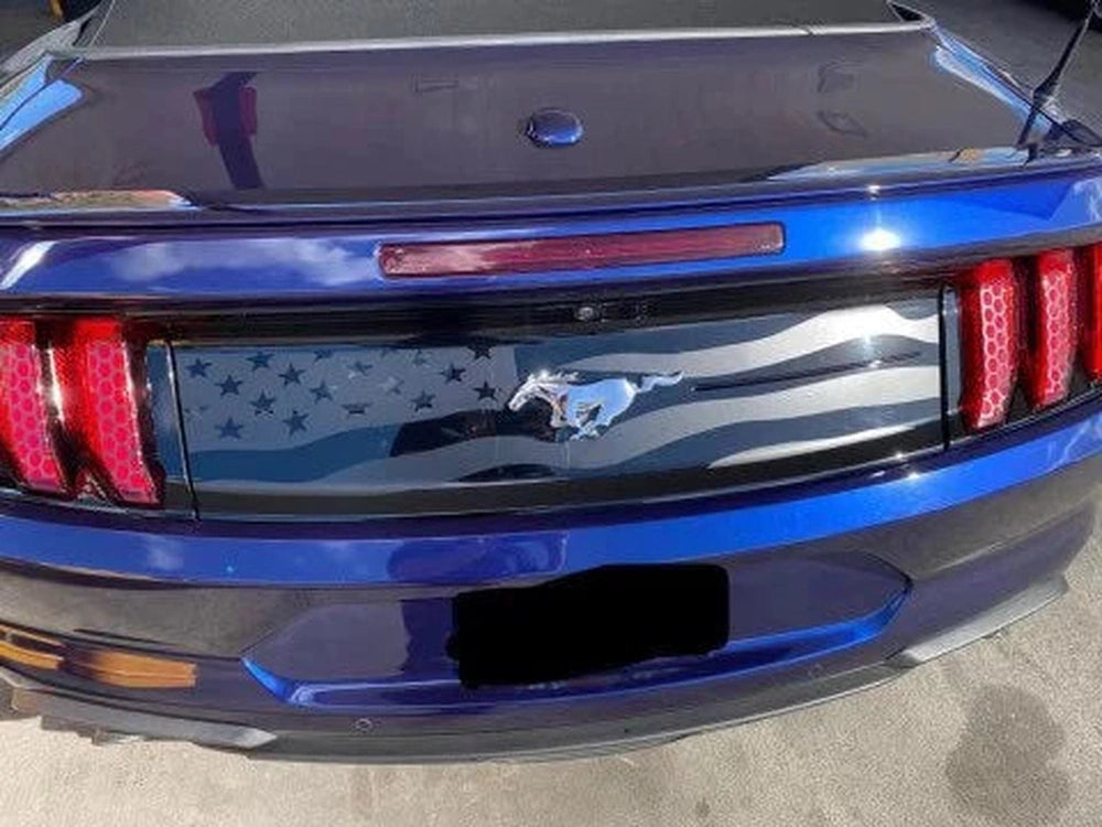 Blue Ford Mustang rear view showcasing American flag decklid decal with matte black stars and stripes, highlighting custom styling for S550 model years 2015-2023