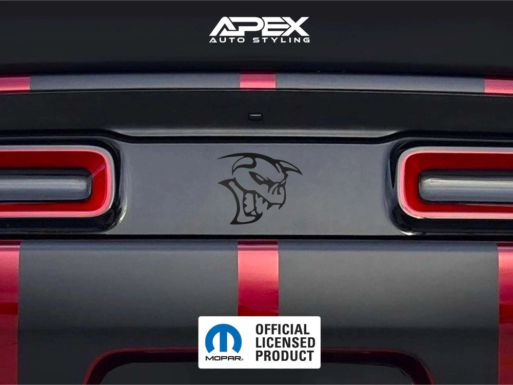 Dodge Challenger taillight divider with SRT Ghoul logo decal, showcasing customizable design between red taillights on black and red striped rear panel, with Apex Auto Styling branding visible